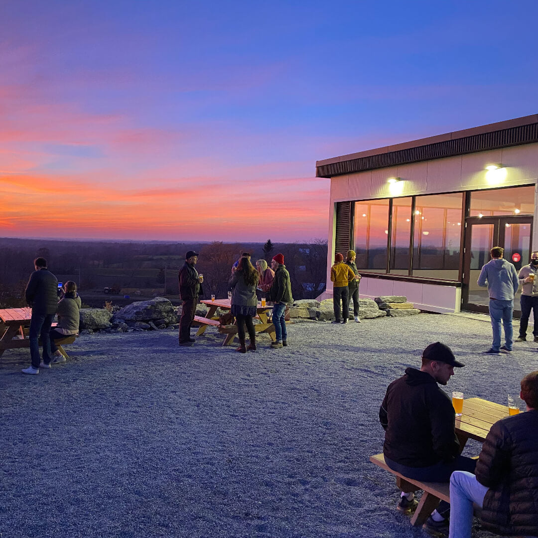 Patio and people at Slake Brewing during sunset